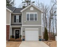 Charming townhouse with a single-car garage, gray siding, black shutters, and a well-maintained lawn at 1109 Banworth Ct, Mebane, NC 27302