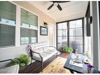 Inviting sunroom featuring a comfortable sitting area and lots of natural light at 125 Canary Ct. Ct, Raleigh, NC 27610