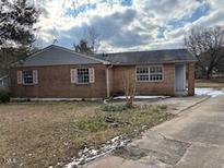 Brick ranch house with attached carport and landscaped yard at 14 Manson Pl, Durham, NC 27703