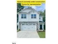 Two-story home with stone accents and a two-car garage at 1701 Drayton Hall Ln, Sanford, NC 27330