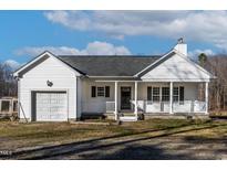 White house with a garage and front porch at 2579 Moss Ledford Rd, Franklinton, NC 27525