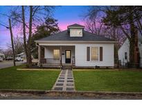 Charming white bungalow with a spacious front yard and stone pathway at 2701 Lawndale Ave, Durham, NC 27705