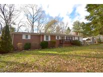 Brick ranch home with a spacious yard and mature trees at 315 Lakeshore Dr, Hillsborough, NC 27278