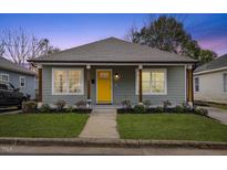 Charming craftsman style home with gray siding and a bright yellow front door at 504 Branch St, Raleigh, NC 27601