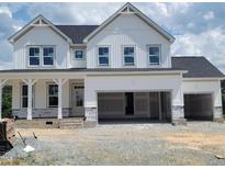 A modern two-story home with white siding, a dark roof, and an attached two-car garage at 53 Priming Way, Angier, NC 27501