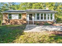 Brick ranch home with solar panels and landscaped yard at 1317 Sedwick Rd, Durham, NC 27713