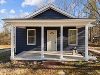 Newly renovated home featuring a charming front porch and dark blue exterior at 1917 Faucette Ave, Durham, NC 27704