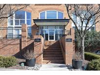 Brick building exterior with entrance, stairs, and landscaping at 200 S Dawson St # 209, Raleigh, NC 27601