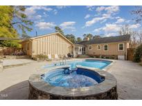 Inviting backyard oasis featuring a sparkling pool and relaxing hot tub at 2009 Mallard Ln, Raleigh, NC 27609