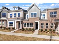 Charming townhouse with a brick facade, symmetrical windows, and manicured landscaping in a suburban neighborhood at 288 Chesapeake Commons St # 149, Garner, NC 27529