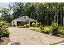 Charming one-story house with a gray exterior, landscaped yard, and a spacious driveway at 619 Barbour St, Clayton, NC 27520