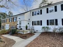 Charming townhouse with black shutters, decorative wreath, and beautifully manicured landscaping at 707 Wade Ave, Raleigh, NC 27605