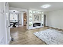 Bright living room with a decorative fireplace and shelving, open to the dining area at 707 Wade Ave, Raleigh, NC 27605