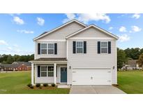Two-story house with light beige siding, a blue door and a two-car garage at 7716 Michelle Rd, Rocky Mount, NC 27803