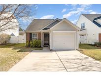 Brick ranch home with attached garage and landscaped yard at 9104 Colony Village Ln, Raleigh, NC 27617