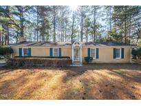 Brick ranch house with a landscaped yard and driveway at 108 Mickey Cir, Durham, NC 27712