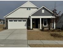 Two-story house with gray and white siding, a stone facade, and a two-car garage at 1315 Richfield Oaks Dr, Homesite 3, Fuquay Varina, NC 27526