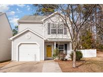 Two-story house with white siding, attached garage, and a yellow front door at 15 Gandhi Dr, Durham, NC 27703