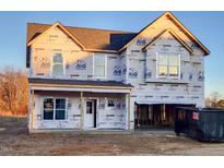 New two-story home with wrap-around porch and attached garage at 236 Johnson Ridge Way, Four Oaks, NC 27524