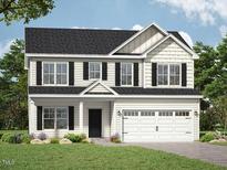 Charming two-story home with a two-car garage, black shutters, and a manicured lawn at 247 Johnson Ridge Way, Four Oaks, NC 27524