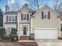 Two-story house with beige siding, maroon shutters, and a two-car garage at 2548 Deanwood Dr, Raleigh, NC 27615