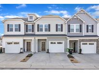 Three-unit townhome building with attached garages and neutral color palette at 431 Leighann Ridge Ln, Rolesville, NC 27571