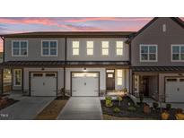 Charming townhome featuring attached garage, craftsman details, and manicured front yard at 610 Marshskip Way, Rolesville, NC 27587