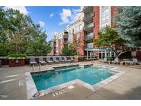 Relaxing pool and lounge area in front of building with brick facade and lots of natural light at 618 N Boylan Ave # 826, Raleigh, NC 27603