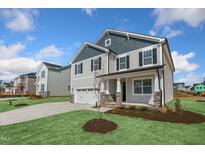 Two-story home with gray siding, stone accents, and a two-car garage at 82 Gin Branch Rd, Wendell, NC 27591
