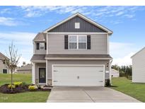 Two-story house with gray siding, white garage door, and landscaping at 821 Rhino Bnd, Oxford, NC 27565
