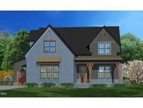 Two-story home with gray siding, brown accents, and a covered porch at 8717 Little Deer Ln, Raleigh, NC 27613