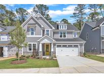 Charming two-story home with gray siding, stone accents, a yellow front door, and a well-manicured lawn at 9164 Dupree Meadow Dr # 14, Angier, NC 27501