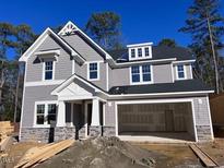 Beautiful two-story home with gray siding, stone accents, and an attached two-car garage at 9164 Dupree Meadow Dr # 14, Angier, NC 27501