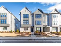 Three-story townhouses with gray siding, modern design, and landscaping at 1179 Cottonsprings Dr, Wendell, NC 27591