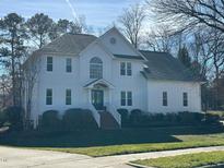 Two-story white house with a charming front porch and landscaping at 124 Dallavia Ct, Morrisville, NC 27560