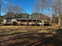 Single-wide manufactured home with covered porch and large yard at 165 Wakeline Dr, Wendell, NC 27591