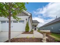 Charming home featuring an attached garage, well-manicured lawn, and inviting curb appeal at 212 War Admiral Dr, Clayton, NC 27520