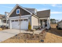 Two-story Craftsman style home with a two car garage and landscaped front yard at 212 War Admiral Dr, Clayton, NC 27520