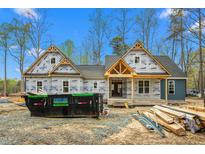 New home construction shows the gable style and exterior siding with a trash receptacle in the foreground at 260 Ellington Rd, Graham, NC 27253