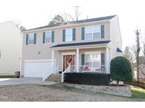Two-story house with beige siding, green shutters, and a stone walkway at 2621 Gross Ave, Wake Forest, NC 27587