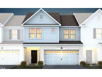 Two-story townhome with gray siding, dark roof, and two-car garage at 299 Broomside Ave, Raleigh, NC 27603
