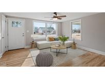 Bright living room boasts hardwood floors, natural light, and stylish contemporary furniture at 322 Pace St, Smithfield, NC 27577