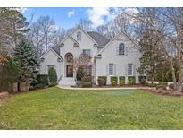 Charming, light brick two-story home with mature landscaping and inviting front lawn at 3225 Mossy Ridge Ct, Raleigh, NC 27613