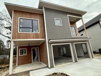 Modern two-story home with wood and gray siding, two-car garage, and a covered porch at 324 Waldo St, Cary, NC 27511
