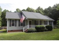 Gray house with white trim, gray shutters, and a white porch at 3413 Thistledown Ct, Efland, NC 27243