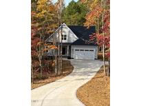 Gray two-story house with a black roof and attached garage, long driveway at 3601 River Watch Ln, Franklinton, NC 27525