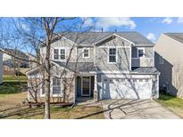 Two-story house with gray siding, stone accents, and a two-car garage at 4104 Twin Spires Dr, Knightdale, NC 27545