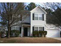 Charming two-story home featuring a well-maintained front yard and attached two-car garage at 4216 Ivy Hill Rd, Raleigh, NC 27616