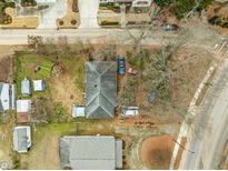Aerial view of a house and surrounding property, including yard and neighboring houses at 517 Kildaire Farm Rd, Cary, NC 27511