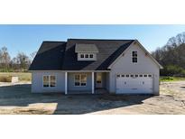 New construction home featuring a two-car garage, covered porch, and modern architectural design at 6294 River Rd, Fuquay Varina, NC 27526